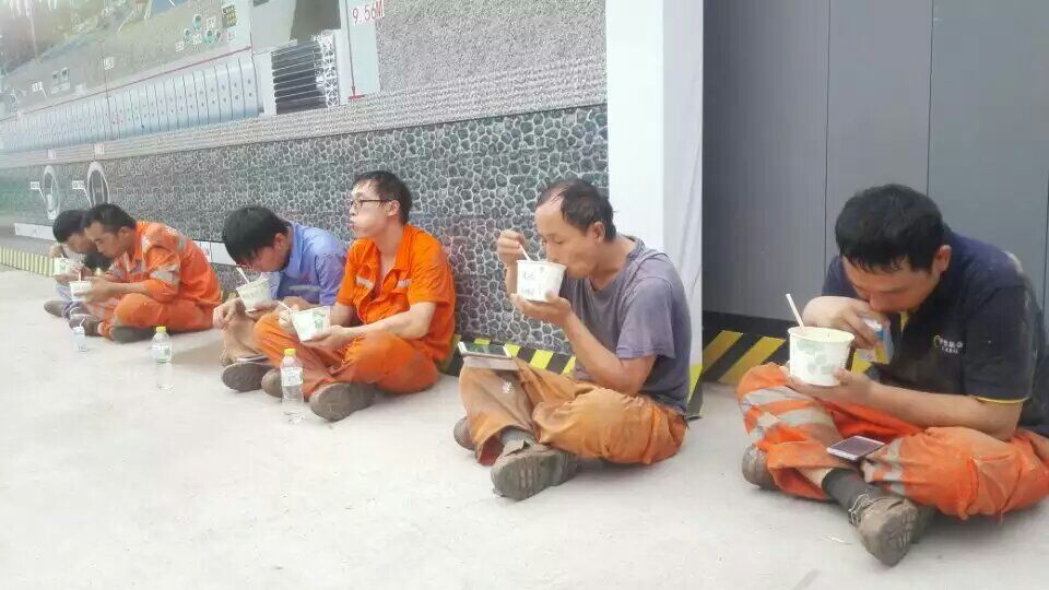 成都頂管機維修改造現(xiàn)場，一線人員席地而坐吃著快餐，只求多點時間解決問題